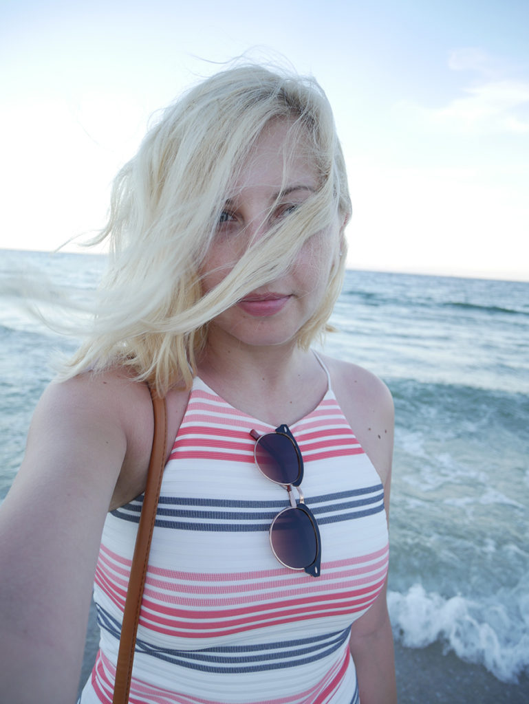 a blonde woman, hair blowing in the wind