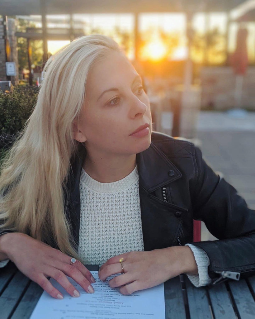 Photo of Kateryna Topol at a dining table at Redstone Winery & Restaurant