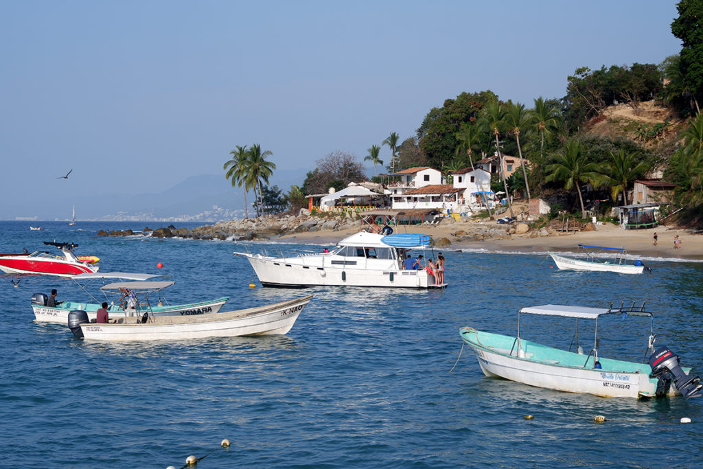 Hiking the Puerto Vallarta's Boca de Tomatlan trail: fishing boats in front of a busy beach