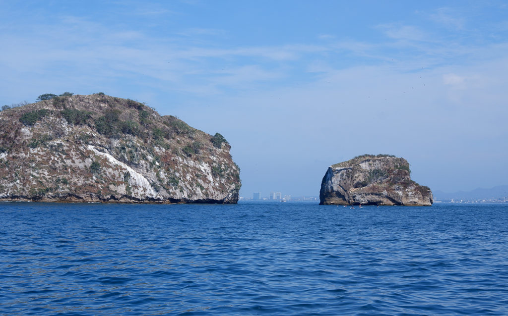 Islas Marietas by boat or No more tequila for Brenda view of the rocky islands near shore in blue water