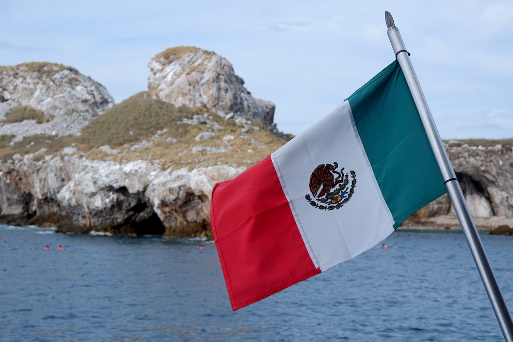 Islas Marietas by boat or No more tequila for Brenda. Image of the Mexican flag in front of the island 