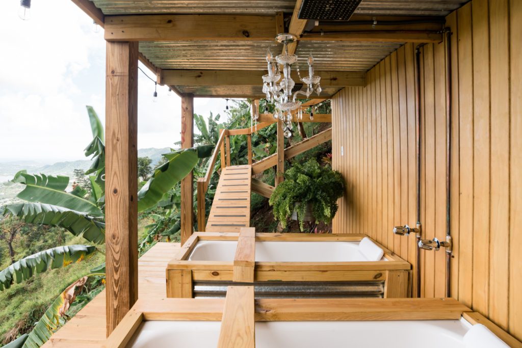 6 unique AirBNB homes in unique locations: outdoor area with two baths looking into the forest