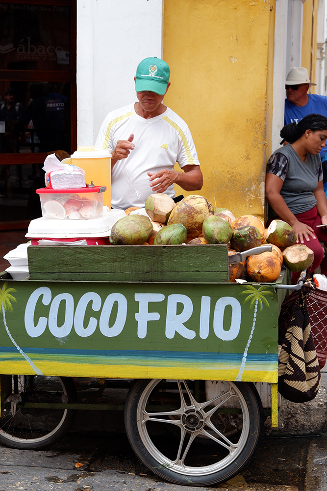 What to do and see Cartagena's Walled City and other Colombian basics: street vendor selling fresh coconuts from a cart