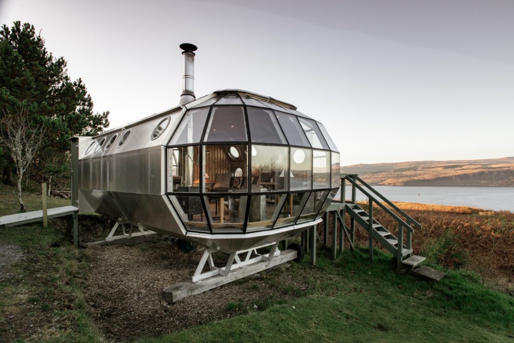 6 unique AirBNB homes in unique locations: a metal glass home with a unique shape