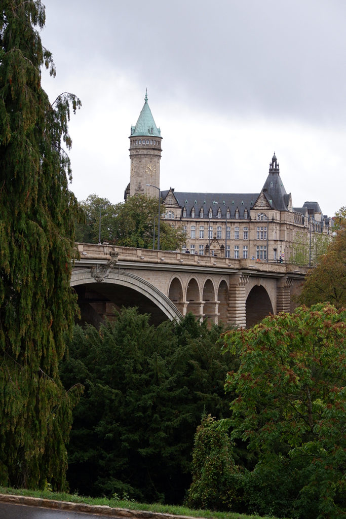 Hello Luxembourg! Let’s see what you’re made of: view of the castle behind the trees across the bridge