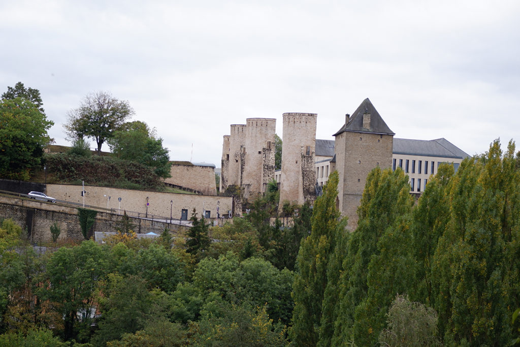 Hello Luxembourg! Let’s see what you’re made of: view of a castle behind green trees