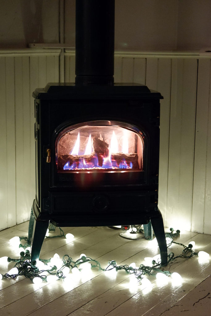 Finding ways to release the pandemic-related apathy in small strides: indoor fire place with christmas lights around it