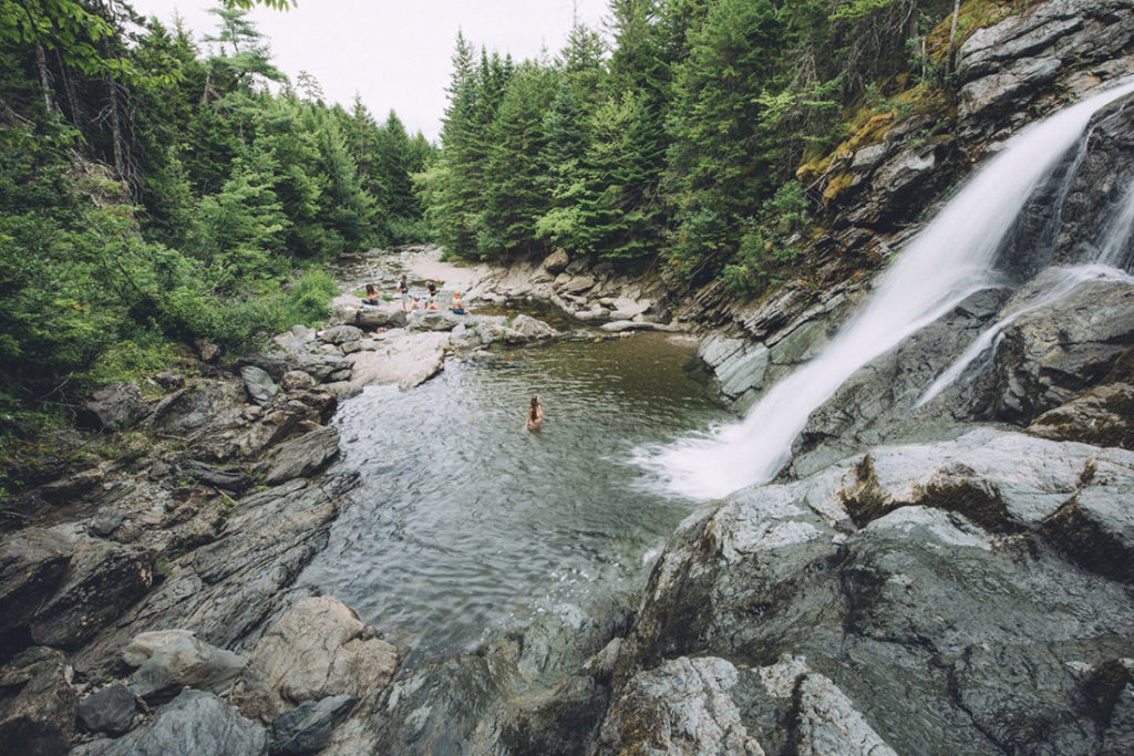 Planning a trip through New Brunswick's Bay of Fundy region: view of a waterfall crushing into a small lake