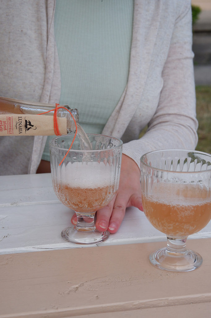 Orange wine being poured into a glass 