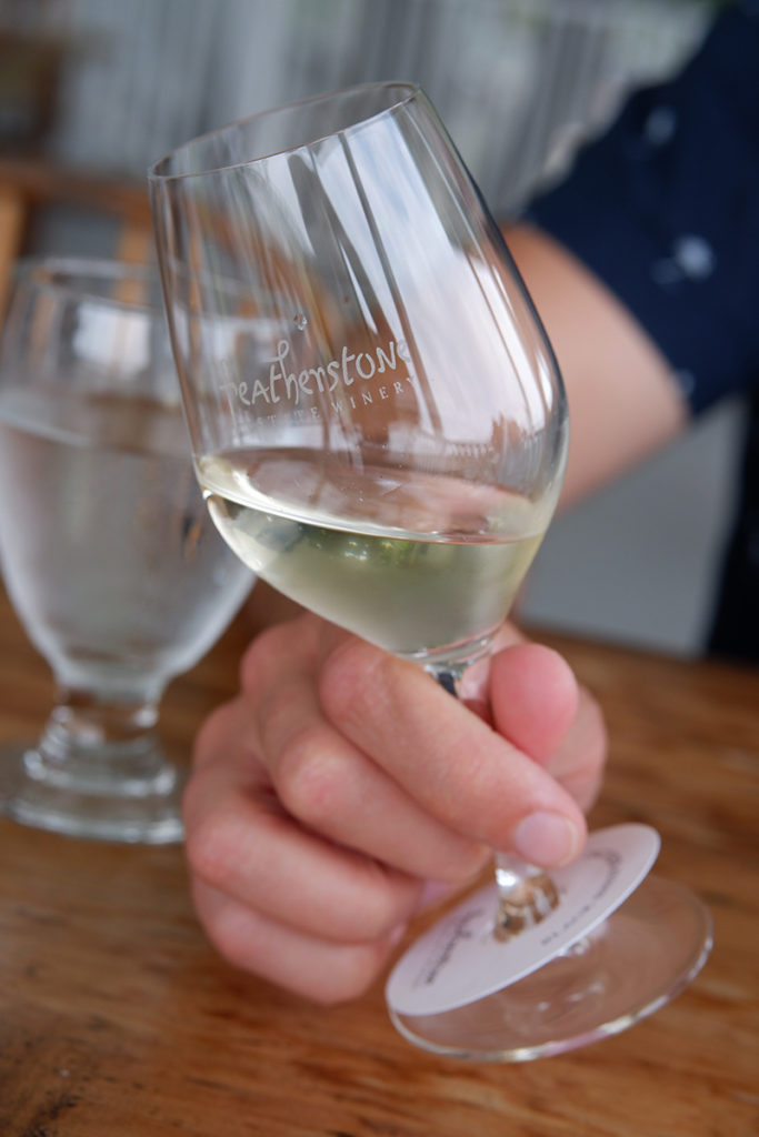 A guide to the Twenty Valley wine region: a white glass of wine at Featherstone 