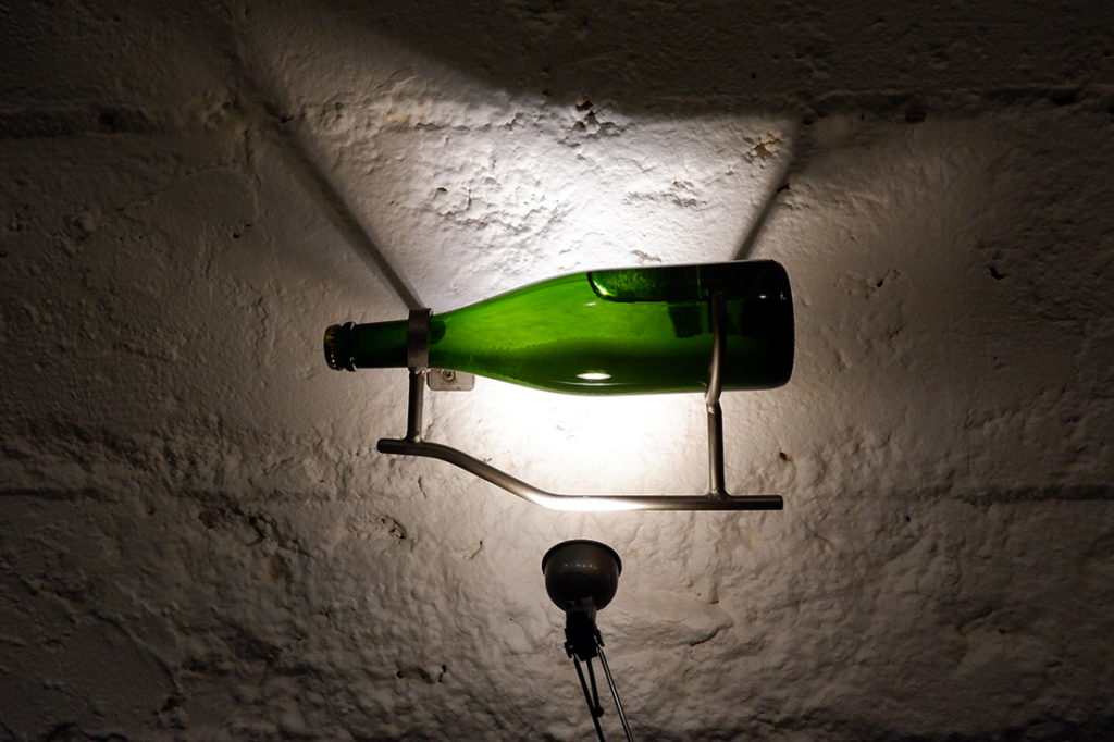 The views & flavours of the Luxembourg wine country: green wine bottle hanging on the wall backlist 