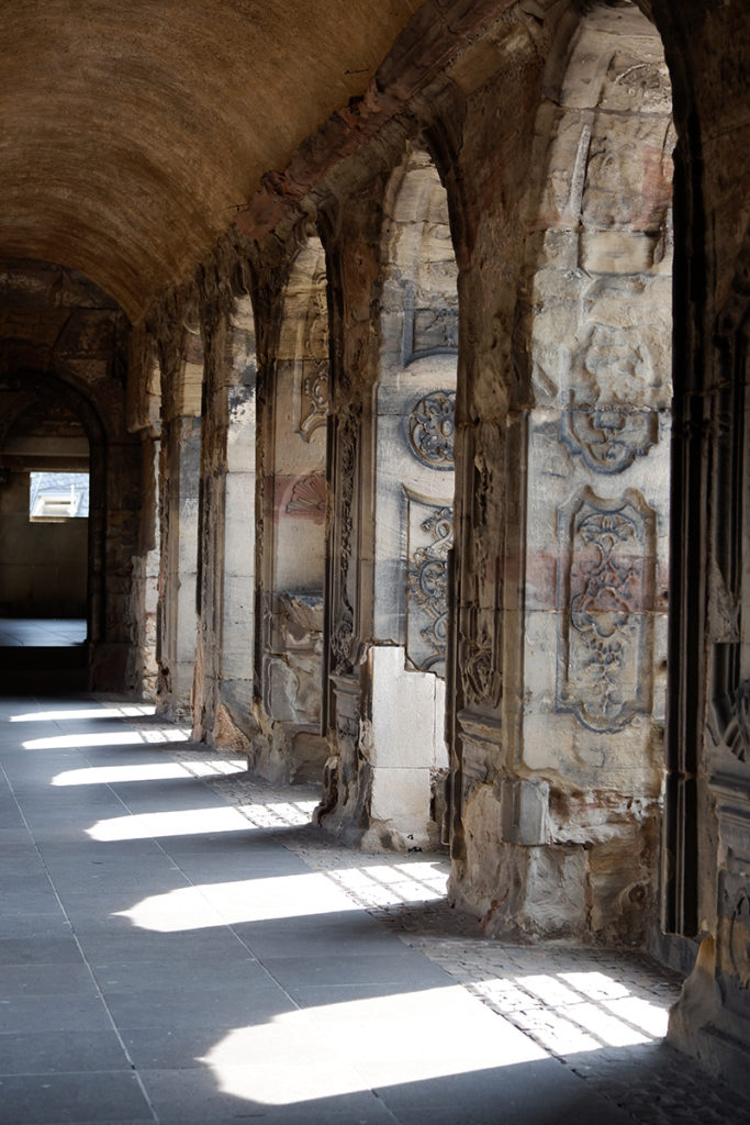 The Porta Nigra hallway with windows lined up, sun coming through 