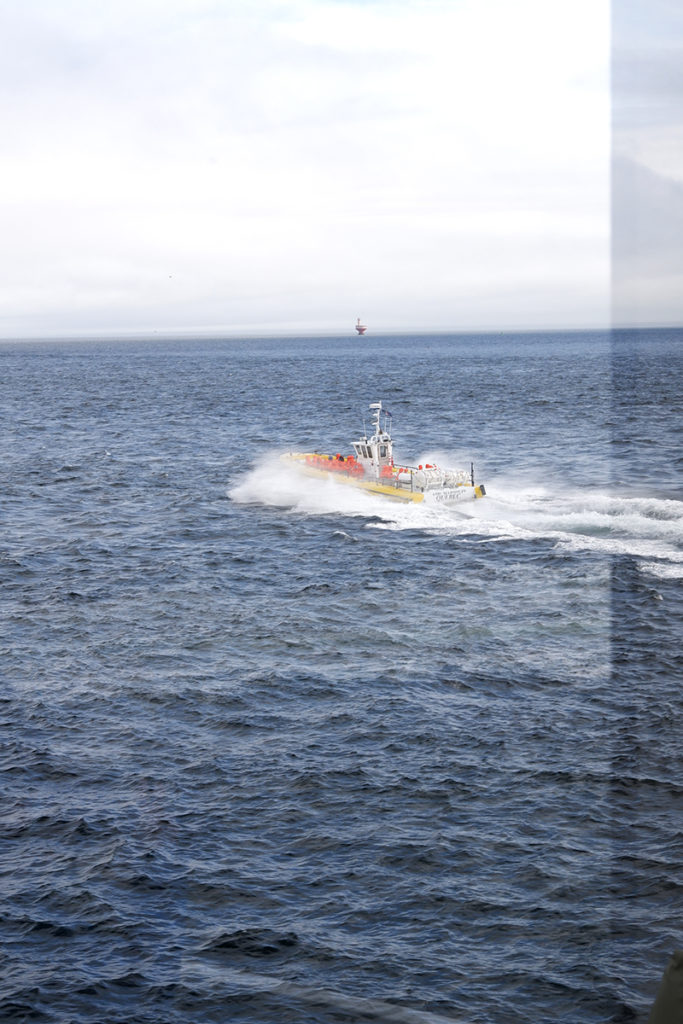 Whale watching in Québec Maritimes: zodiac boat in the distance 