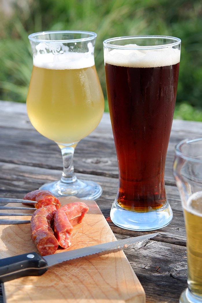 Destination guide: The great adventure through Quebec Maritimes - two glasses of beer with sausages