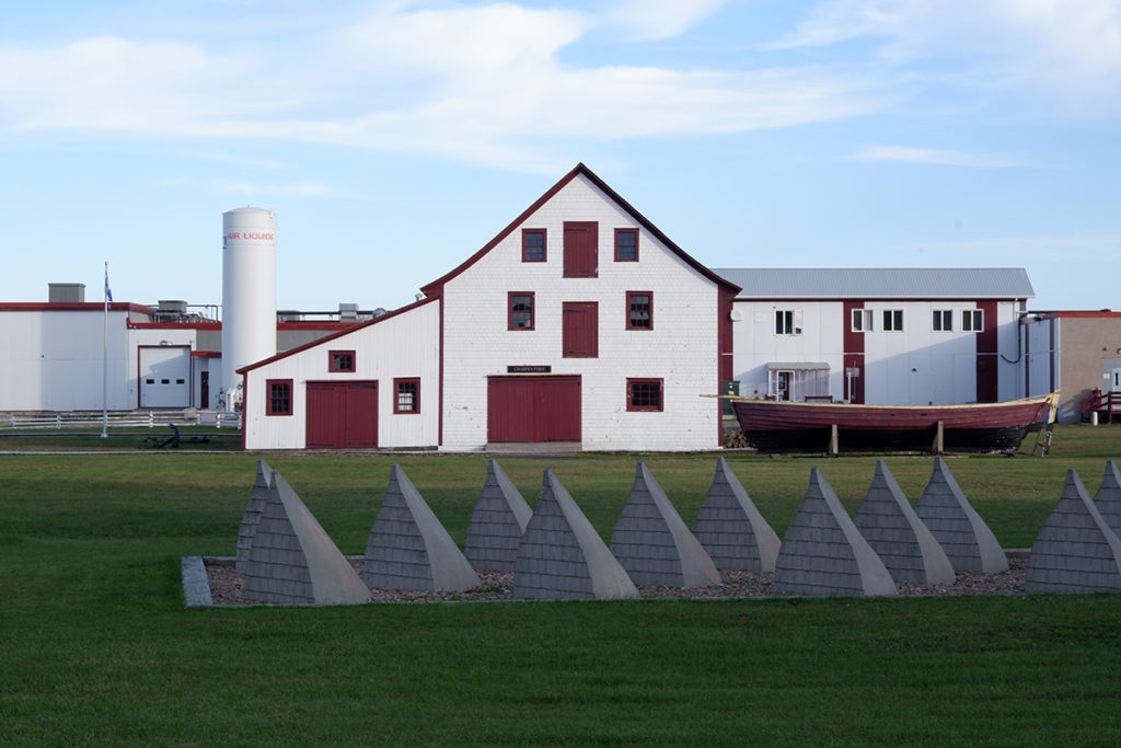 Destination guide: The great adventure through Quebec Maritimes - white house with a boat art piece 