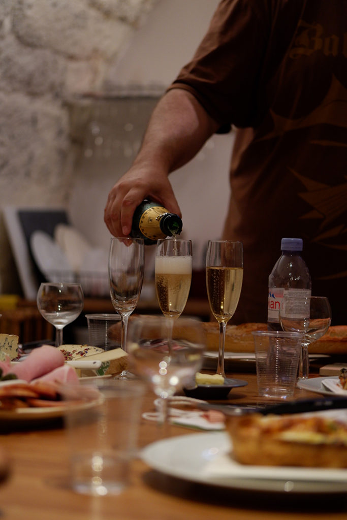 Kateryna Topol photo portfolio: a line of champagne glasses being poured by a male hand