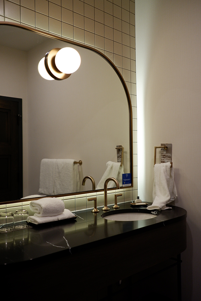 The Westley Calgary Downtown, gold trimmed mirror in the bathroom