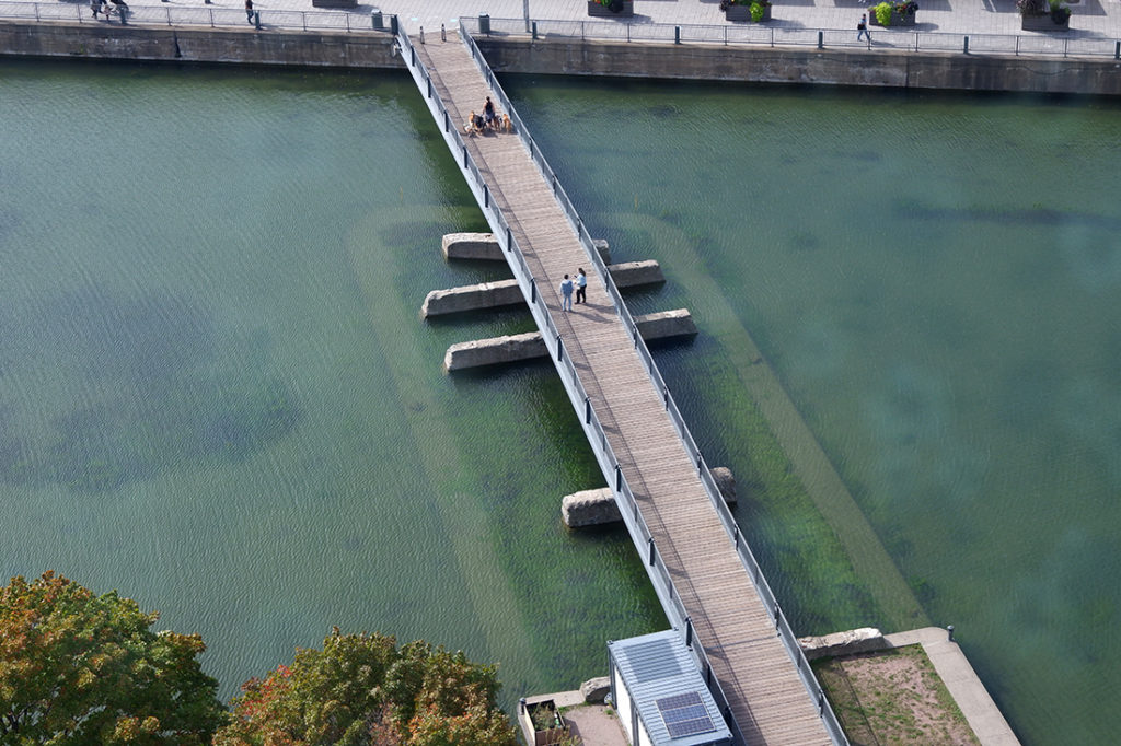 Board walk over water leading to the ferris wheel