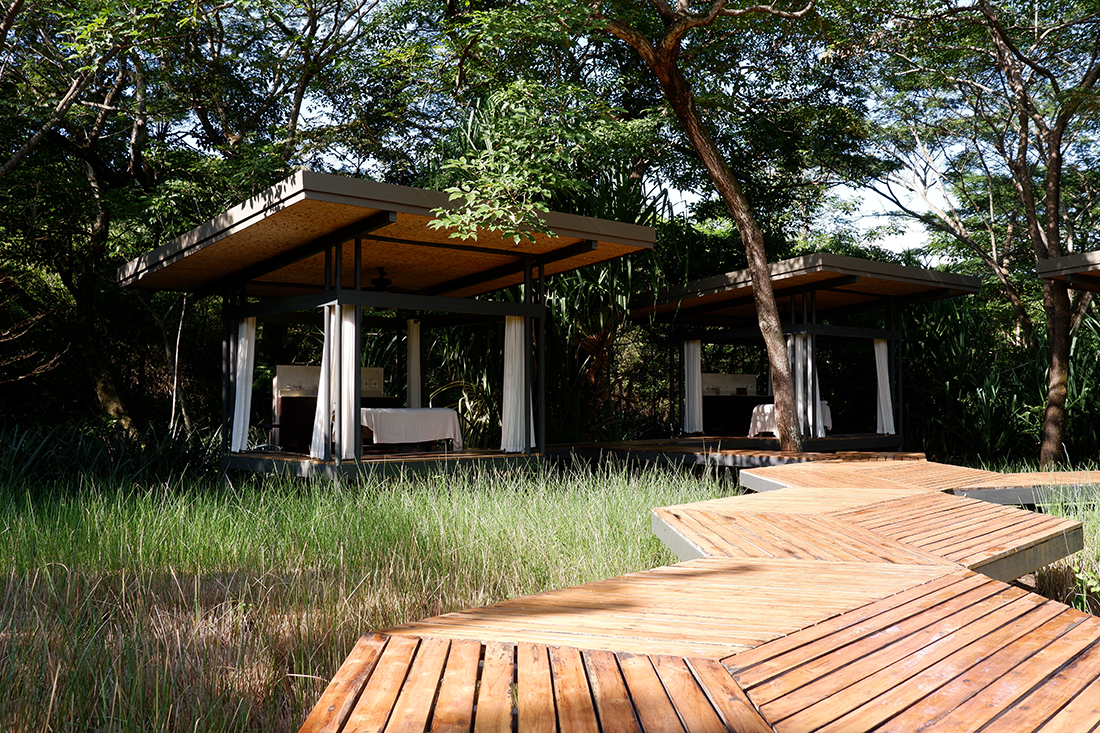 Outdoor spa at the El Mangroove Hotel, Costa Rica. View of the wooden trail toward the massage beds