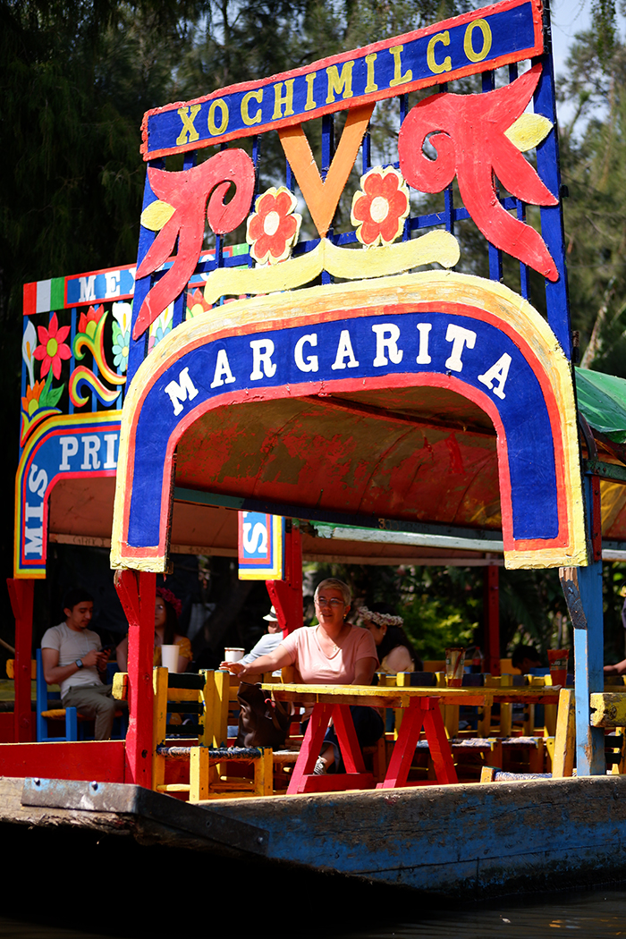 Mexican boat, called trajinera with the title "margarita" on it, colourful decorated 