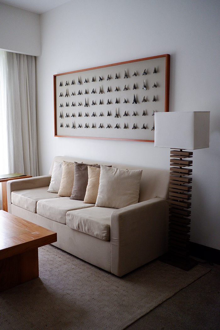 Sleep among the mangrove trees at El Mangroove Hotel, Habitat Superior suite couch with local wall art