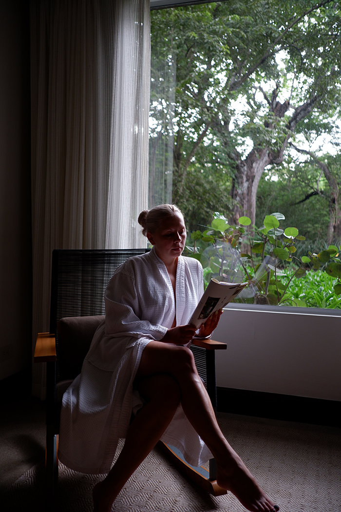 El Mangroove Hotel, Habitat Superior suite picture window and rocking chair with a woman sitting in it. Costa Rica