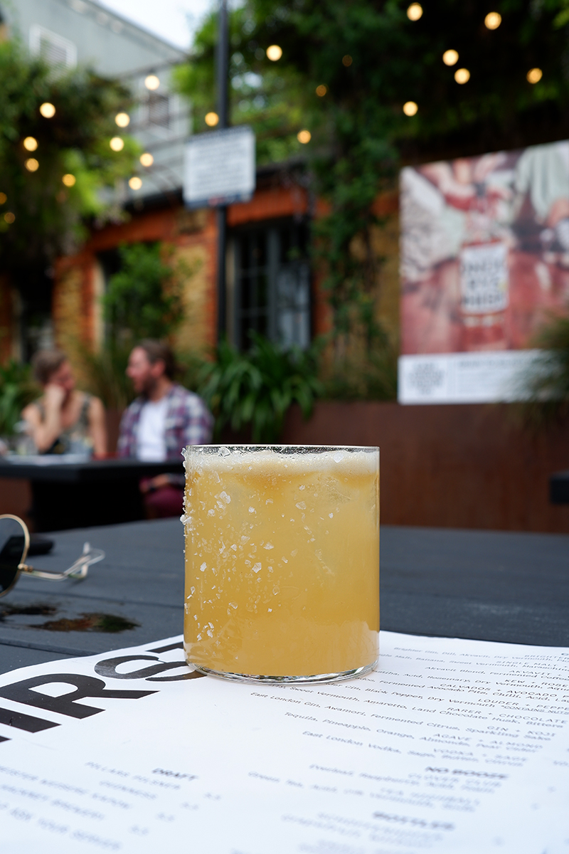 My 5 favourite bars and restaurants in London: a cocktail in a short glass on a patio table at East London Liquor Company (ELLC)