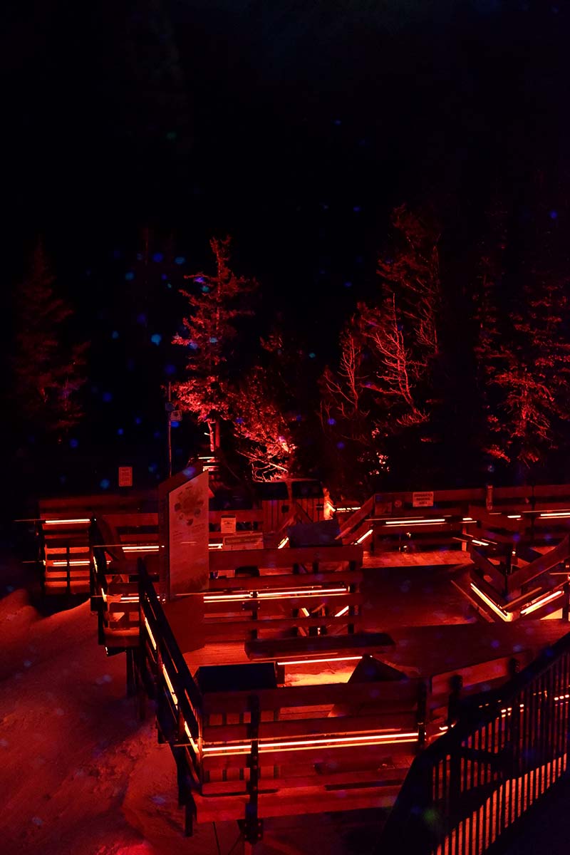 Five things to do in Banff for non-skiers: Sulphur Mountain boardwalk at night lit up with red lights