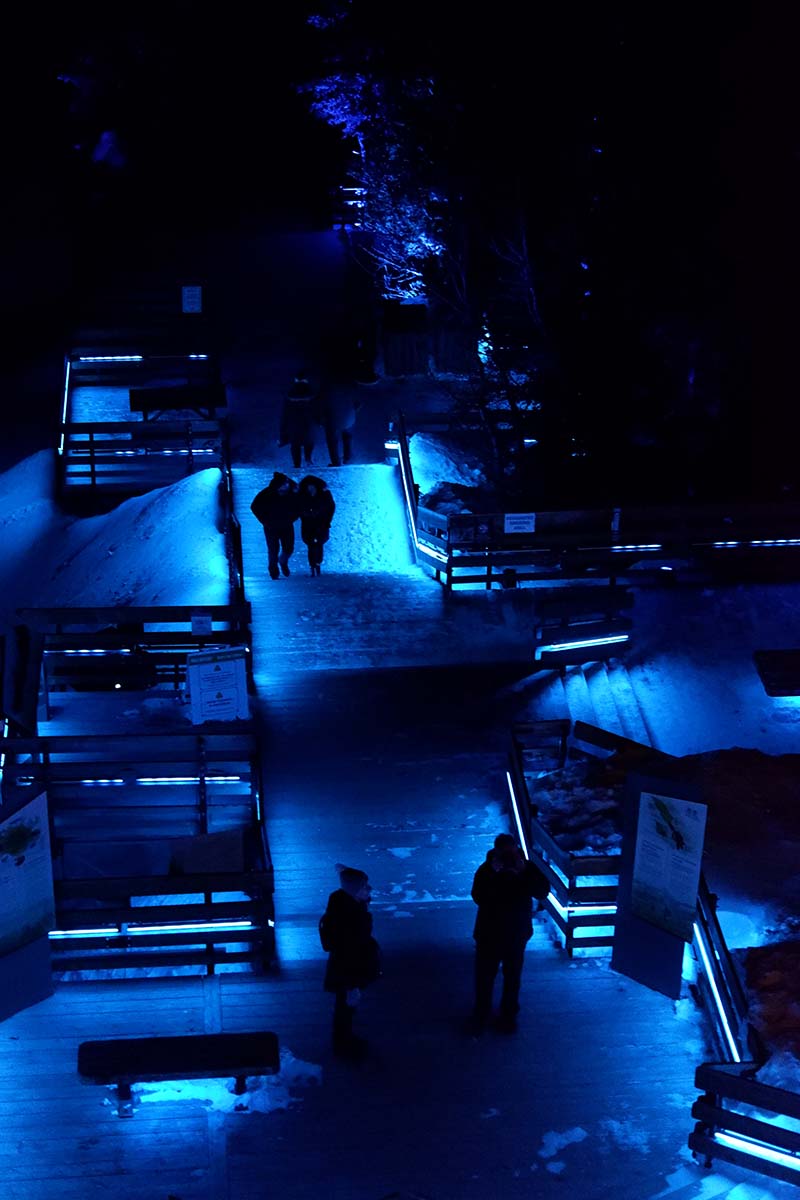 Five things to do in Banff for non-skiers: Sulphur Mountain boardwalk at night lit up with blue lights