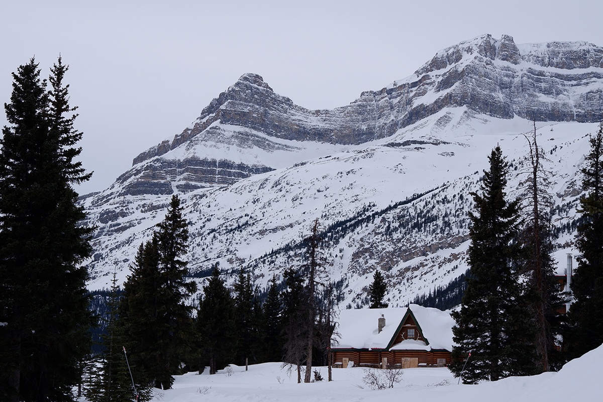 Five things to do in Banff for non-skiers: view of the snow-covered mountain and a small chalet at the foot of it