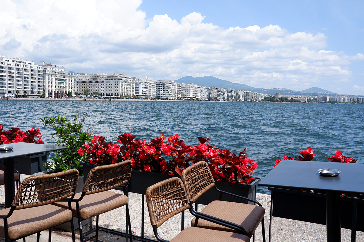 45 Photos to inspire you to visit  Thessaloniki waterfront seen from a patio with red flower planters