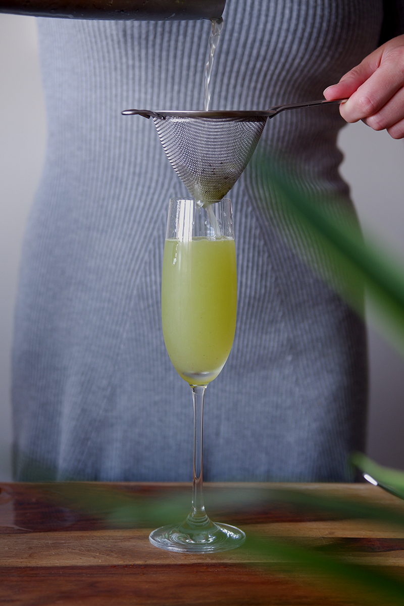 Seeing Greece through the cherry & kiwi fields : kiwi spritz recipe, cocktail being poured into a champagne glass 