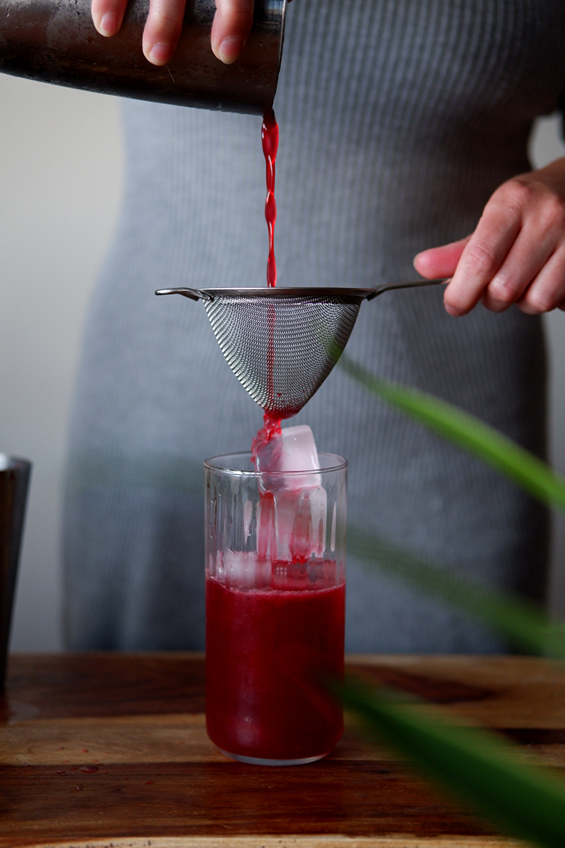 Seeing Greece through the cherry & kiwi fields: cherry cocktail being poured over ice 