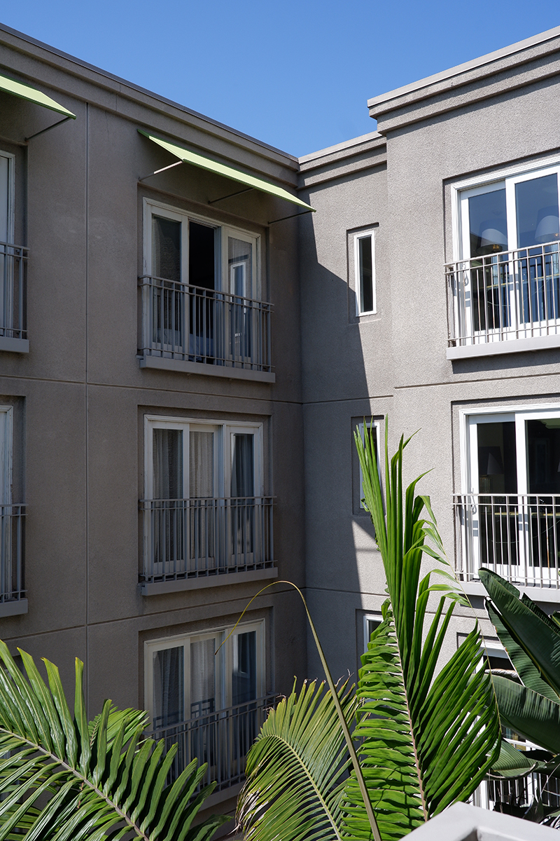 Hotel Amarano, a boutique hotel with a rich Hollywood history: exterior corner of the building with greenery in the foreground 